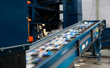 Plastic packaging waste on a sorting belt at the facility of NTCP.