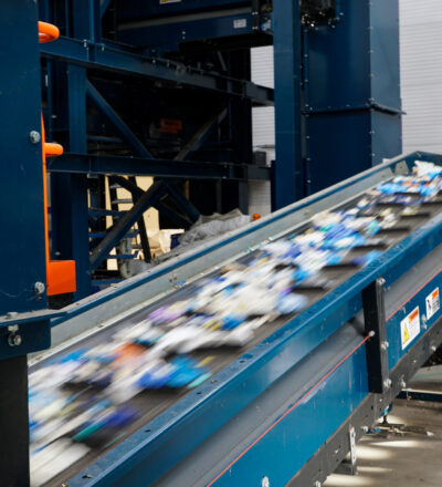 Plastic packaging waste on a sorting belt at the facility of NTCP.